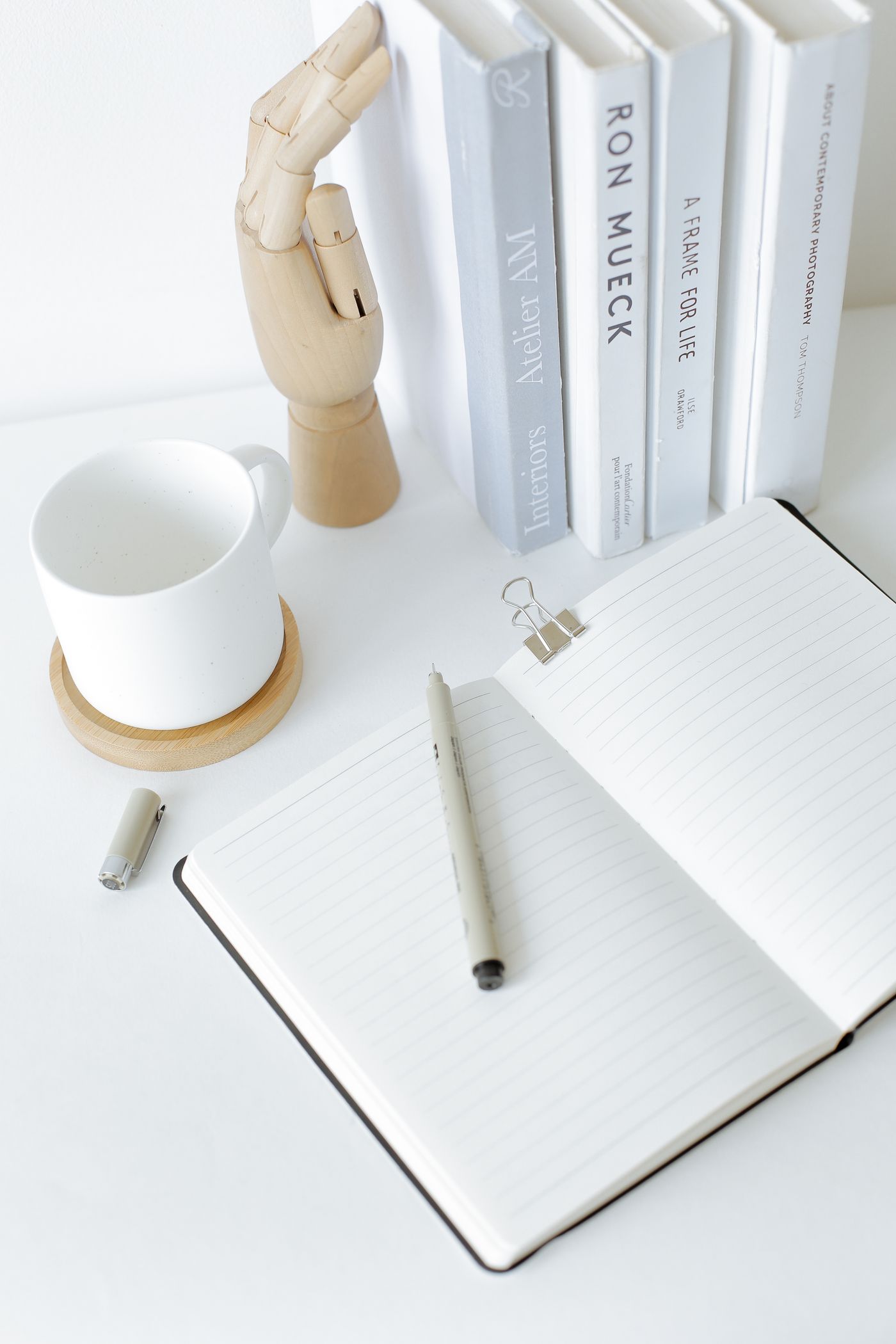 An open notebook and a mug on a calm desk
